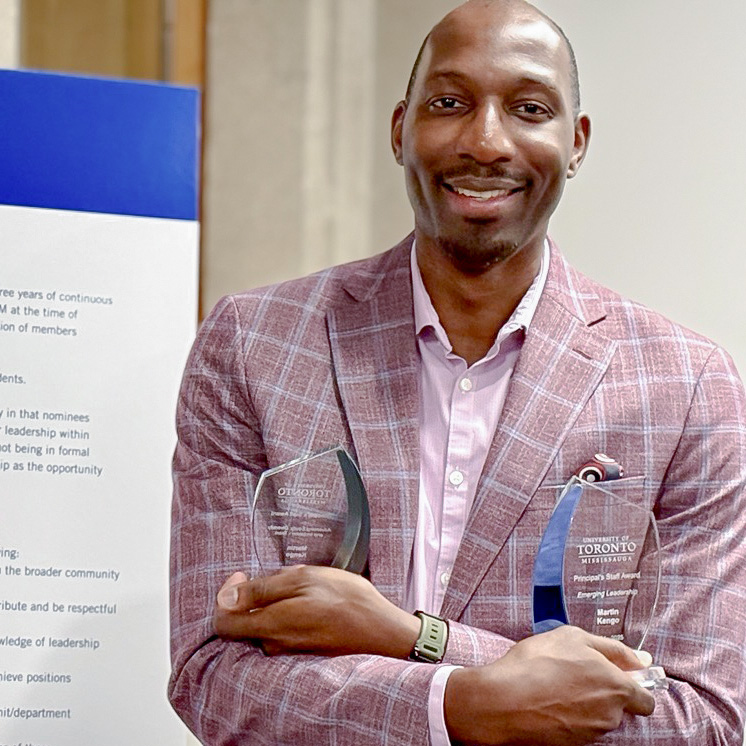 Martin Kengo holding Awards